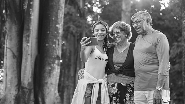 grandparents posing for selfie with granddaughter