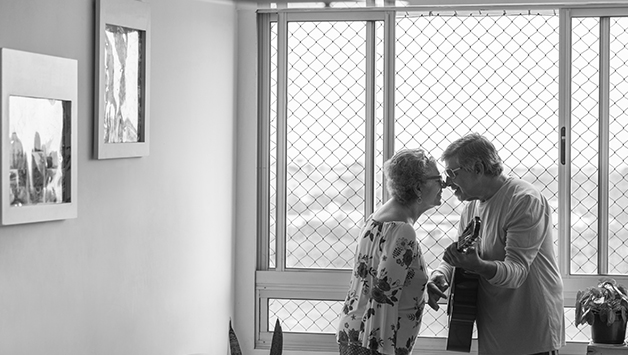 senior couple playing guitar and dancing