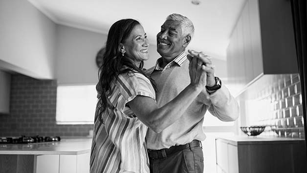 senior couple dancing in the kitchen