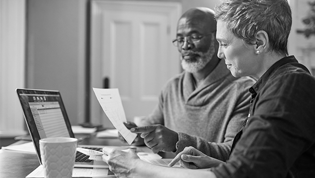 man and woman preplanning on laptop