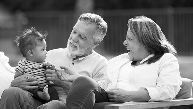 Hispanic grandparents with grandchild outside